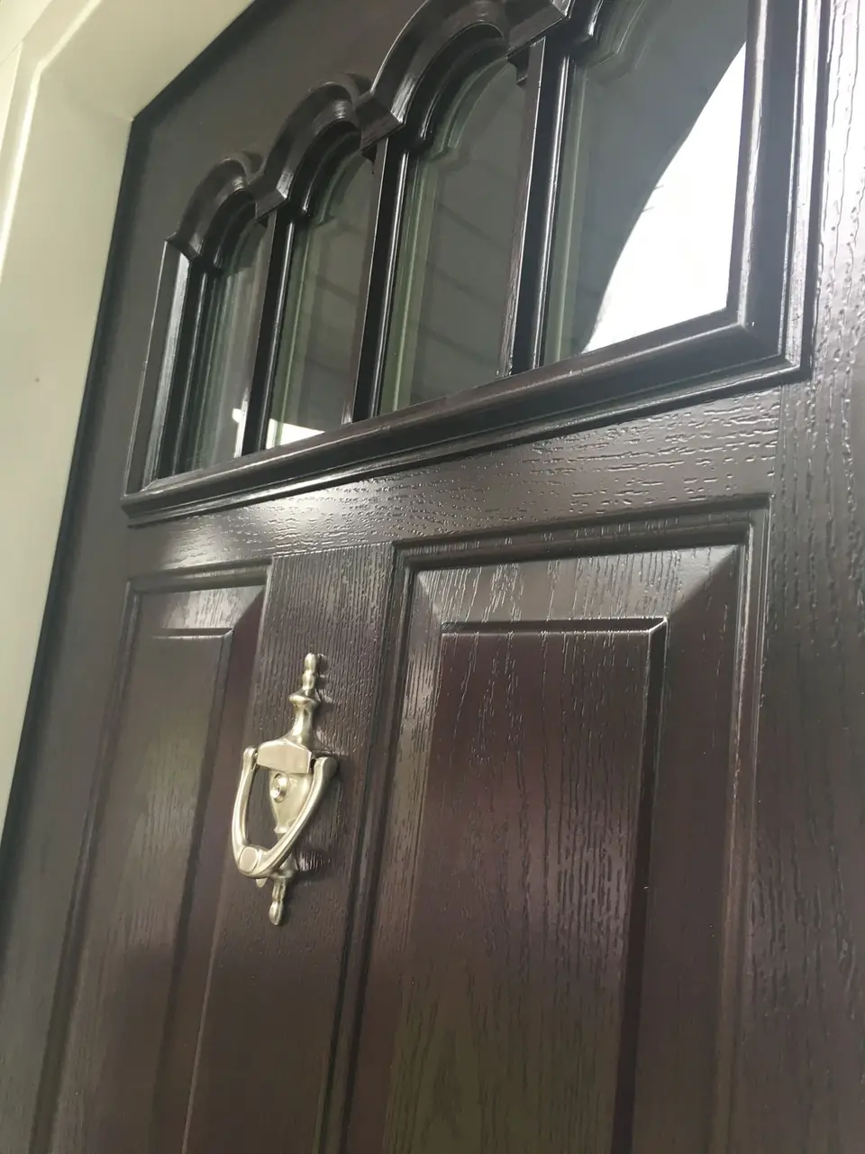 Dark entry door with arched glass