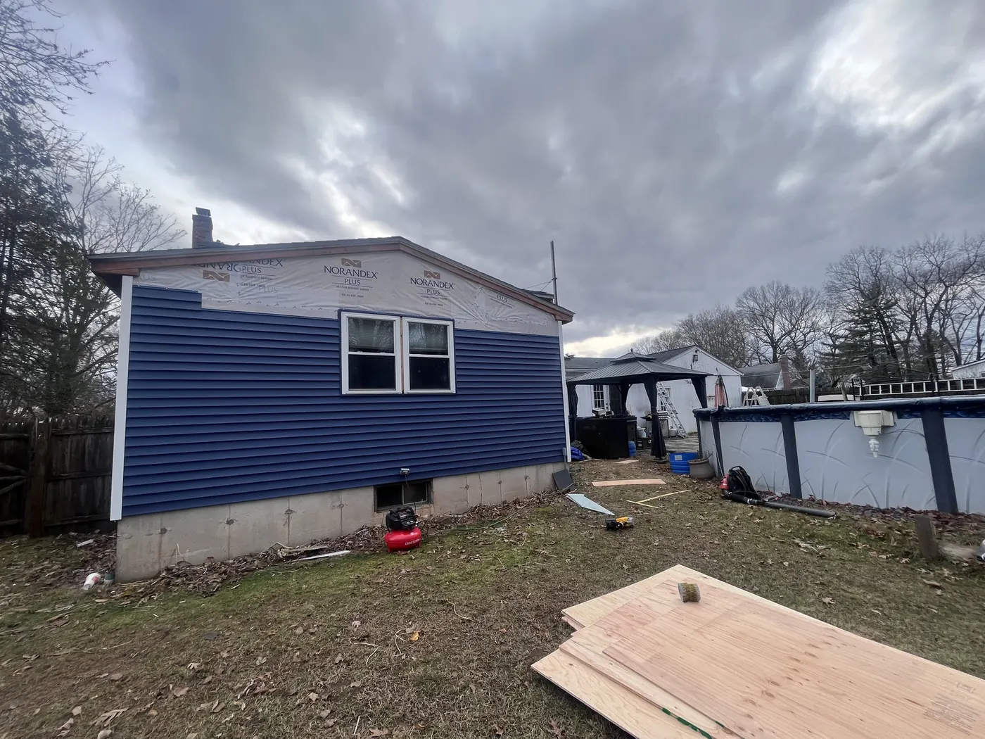 Ranch home with new blue vinyl siding
